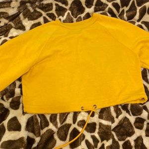 Crew neck cropped sweater with drawstring